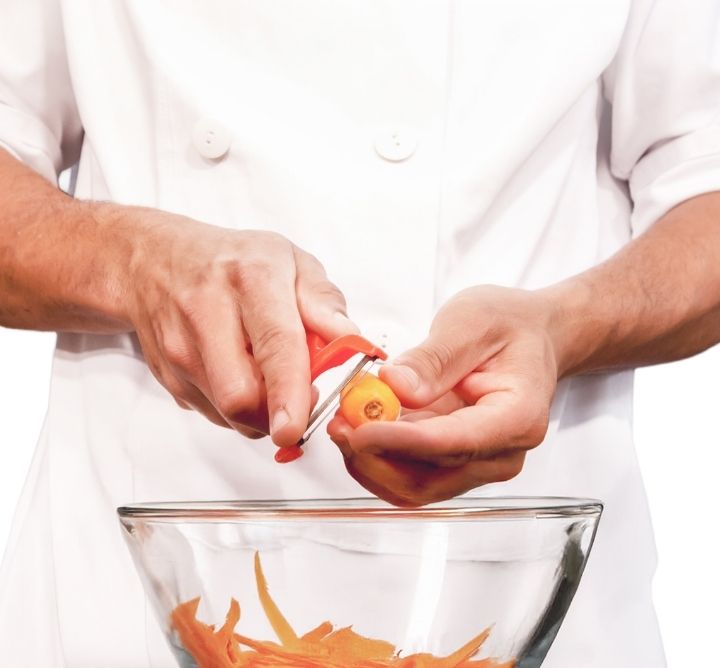 Man peeling carrot. 